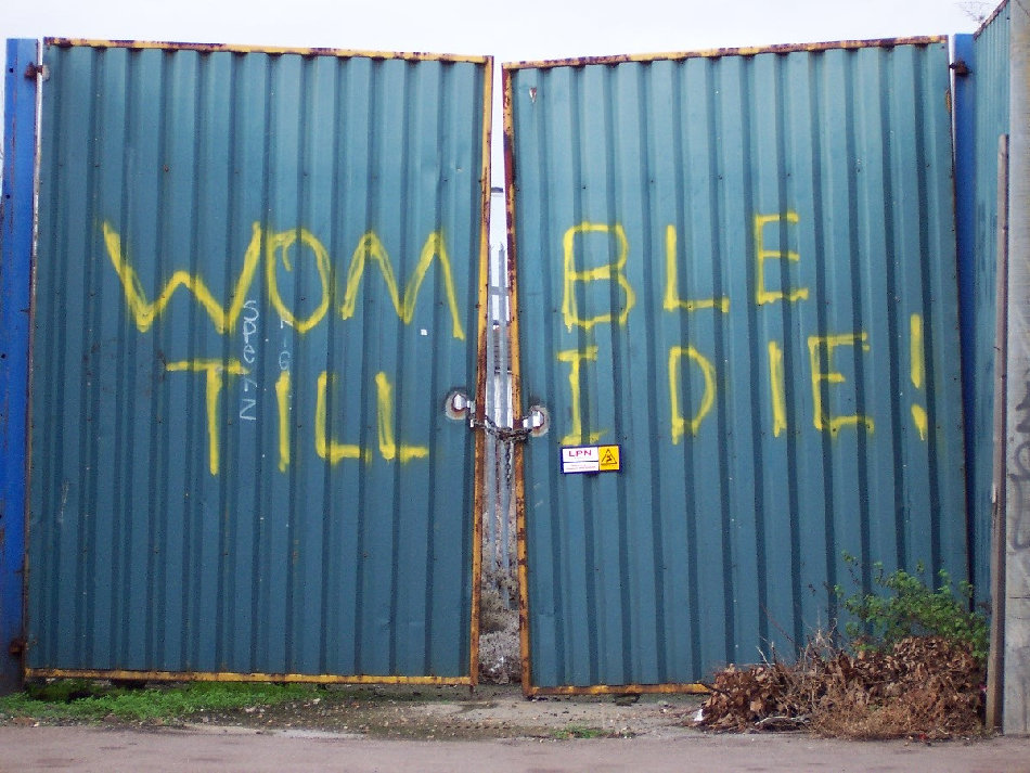 Womble Till I Die! Plough Lane gates.jpg · Anonymous AFC Wimbledon supporter · CC BY-SA 2.0