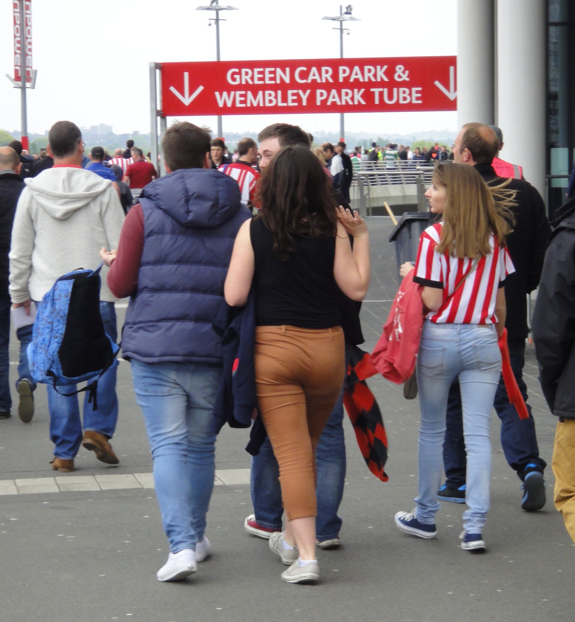 Brentford Play-Off Final - May 2013 , fans walking toward main entrance of stadium (8831693836).jpg · Gareth Williams from Redhill, England · CC BY 2.0